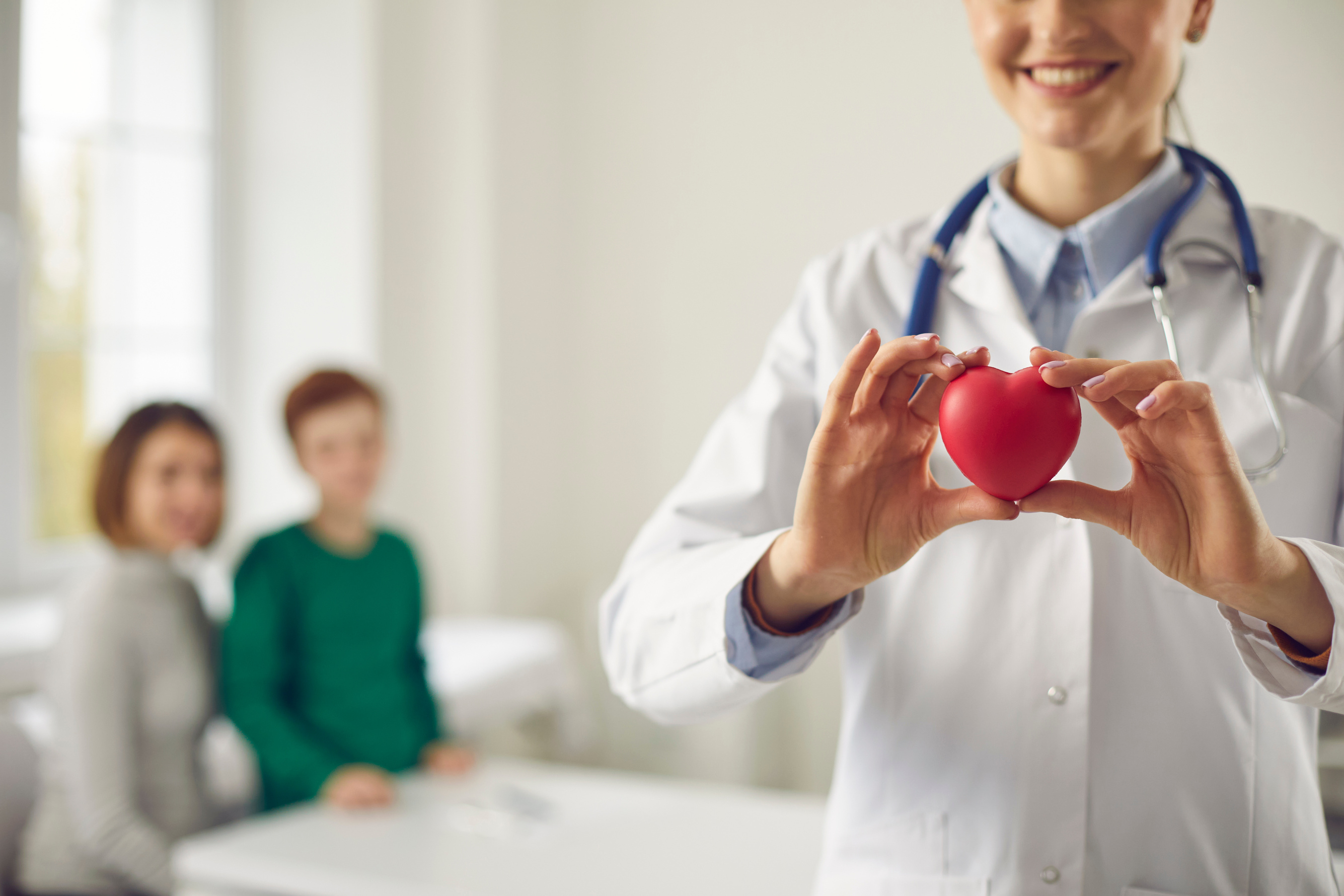 Family Doctor Holding Red Heart, Promoting Healthy Lifestyle and Disease Prevention